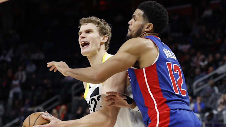 Dec 19, 2024; Detroit, Michigan, USA;  Utah Jazz forward Lauri Markkanen (23) is fouled by Detroit Pistons forward Tobias Harris (12) in the fourth quarter at Little Caesars Arena. Mandatory Credit: Rick Osentoski-Imagn Images