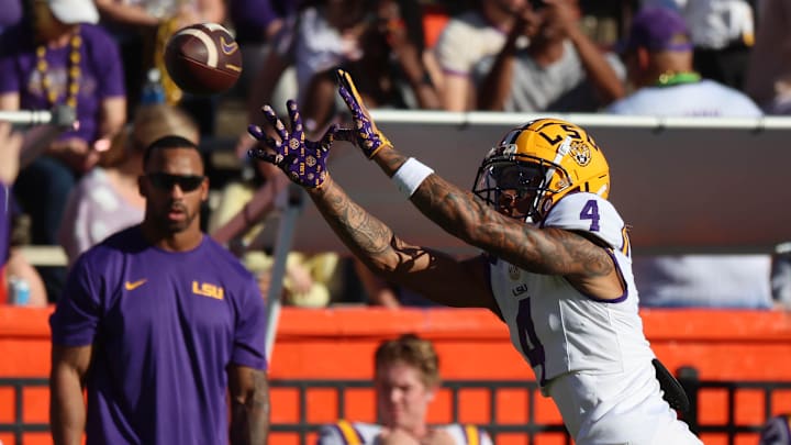 Nov 16, 2024; Gainesville, Florida, USA; LSU Tigers wide receiver CJ Daniels (4) warms up prior to the game against the Florida Gators at Ben Hill Griffin Stadium. Mandatory Credit: Kim Klement Neitzel-Imagn Images