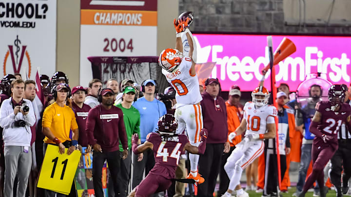 Nov 9, 2024; Blacksburg, Virginia, USA; Clemson Tigers wide receiver Antonio Williams (0) goes up for a catch while being defended by Virginia Tech Hokies cornerback Dorian Strong (44) during the third quarter at Lane Stadium. Mandatory Credit: Brian Bishop-Imagn Images