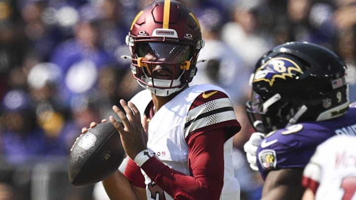 Oct 13, 2024; Baltimore, Maryland, USA;  Washington Commanders quarterback Jayden Daniels (5) loos to throws during the first quarter against the Baltimore Ravens at M&T Bank Stadium. Mandatory Credit: Tommy Gilligan-Imagn Images