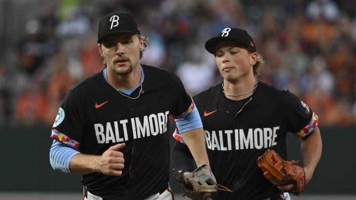 Aug 23, 2024; Baltimore, Maryland, USA;  Baltimore Orioles shortstop Gunnar Henderson (2) and Baltimore Orioles second baseman Jackson Holliday (7) runs off the field after turning a double play in the first inning against the Houston Astros at Oriole Park at Camden Yards. Mandatory Credit: Tommy Gilligan-USA TODAY Sports