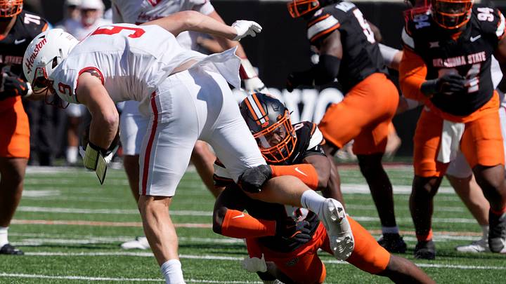 Oklahoma State LB Brandon Rawls ties to bring down Houston TE Tanner Koziol during a college football game between Oklahoma State and Houston. Houston won 39-17. Oklahoma State LB Brandon Rawls ties to bring down Houston TE Tanner Koziol during a college football game between Oklahoma State and Houston. Houston won 39-17.
