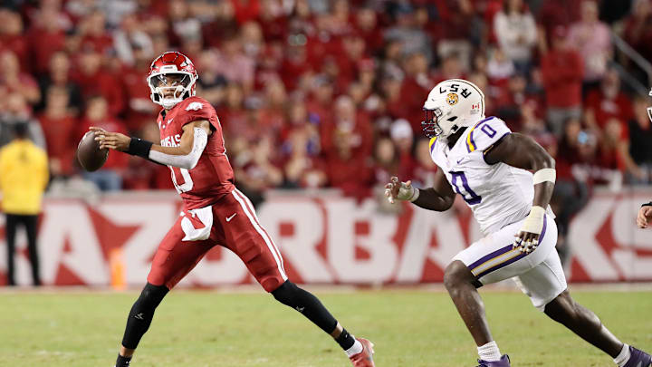 Oct 19, 2024; Fayetteville, Arkansas, USA; Arkansas Razorbacks quarterback Taylen Green (10) passes as LSU Tigers defensive end Paris Shand (0) defends during the second quarter at Donald W. Reynolds Razorback Stadium. Mandatory Credit: Nelson Chenault-Imagn Images