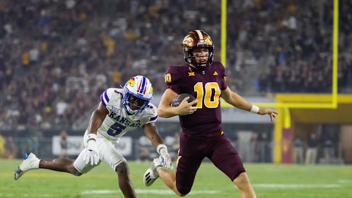 Oct 5, 2024; Tempe, Arizona, USA; Arizona State Sun Devils quarterback Sam Leavitt (10) is pushed out of bounds by Kansas Jayhawks safety O.J. Burroughs (5) in the second half at Mountain America Stadium. Mandatory Credit: Mark J. Rebilas-Imagn Images Oct 5, 2024; Tempe, Arizona, USA; Arizona State Sun Devils quarterback Sam Leavitt (10) is pushed out of bounds by Kansas Jayhawks safety O.J. Burroughs (5) in the second half at Mountain America Stadium. Mandatory Credit: Mark J. Rebilas-Imagn Images