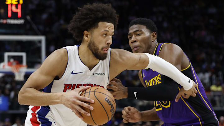 Nov 4, 2024; Detroit, Michigan, USA;  Detroit Pistons guard Cade Cunningham (2) dribbles defended by Los Angeles Lakers forward Rui Hachimura (28) in the second half at Little Caesars Arena. Mandatory Credit: Rick Osentoski-Imagn Images