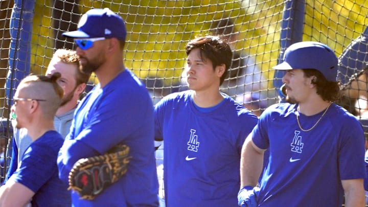 Feb 19, 2024; Glendale, AZ, USA; Los Angeles Dodgers designated hitter Shohei Ohtani (17), center, stands next to center fielder James Outman (33) during batting practice at spring training at Camelback Ranch. Mandatory Credit: Jayne Kamin-Oncea-Imagn Images Feb 19, 2024; Glendale, AZ, USA; Los Angeles Dodgers designated hitter Shohei Ohtani (17), center, stands next to center fielder James Outman (33) during batting practice at spring training at Camelback Ranch. Mandatory Credit: Jayne Kamin-Oncea-Imagn Images