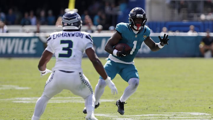 Oct 12, 2025; Jacksonville, Florida, USA; Jacksonville Jaguars running back Travis Etienne (1) runs the ball as Seattle Seahawks safety Nick Emmanwori (3) defends during the first half at EverBank Stadium. Mandatory Credit: Travis Register-Imagn Images Oct 12, 2025; Jacksonville, Florida, USA; Jacksonville Jaguars running back Travis Etienne (1) runs the ball as Seattle Seahawks safety Nick Emmanwori (3) defends during the first half at EverBank Stadium. Mandatory Credit: Travis Register-Imagn Images