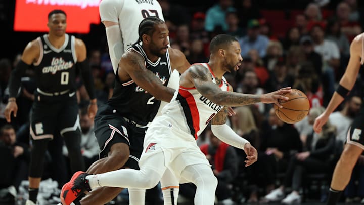 Mar 19, 2023; Portland, Oregon, USA; Portland Trail Blazers guard Damian Lillard (0) dribbles the ball against LA Clippers forward Kawhi Leonard (2) in the first half at Moda Center. Mandatory Credit: Jaime Valdez-Imagn Images