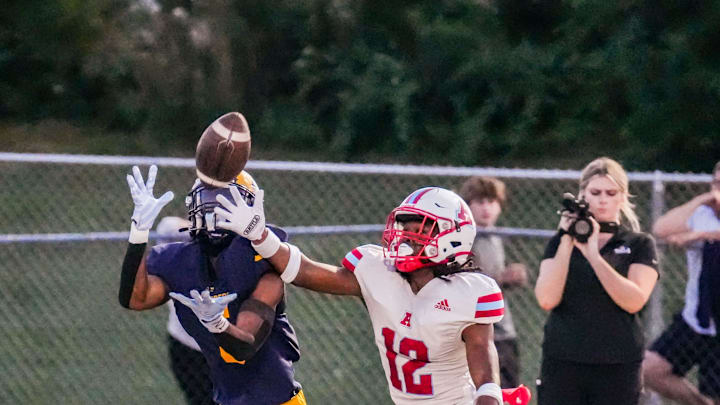 Marquette's Tommy Novotny (5) pulls in a touchdown catch despite close coverage by Arrowhead's Joel Siner (12) during the nonconference season opener at Menomonee Falls on Friday, August 22, 2025. Arrowhead won the game, 53-22.