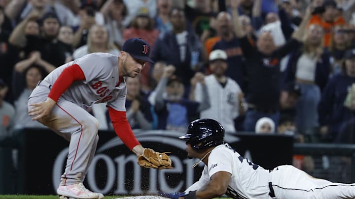 May 14, 2025; Detroit, Michigan, USA;  Detroit Tigers third baseman Andy Ibáñez (77) dives in safely at third ahead of the tag by Boston Red Sox third baseman Alex Bregman (2) in the ninth inning at Comerica Park. Mandatory Credit: Rick Osentoski-Imagn Images