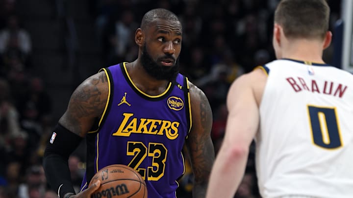 Feb 22, 2025; Denver, Colorado, USA; Los Angeles Lakers forward LeBron James (23) holds the ball during the second half against the Denver Nuggets at Ball Arena. Mandatory Credit: Christopher Hanewinckel-Imagn Images