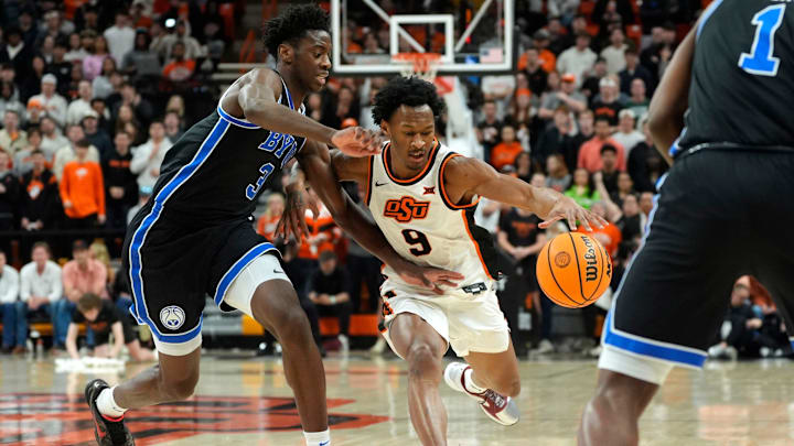 Oklahoma State Cowboys guard Anthony Roy (9) dribbles beside BYU Cougars forward AJ Dybantsa (3) during a BIG 12 men's college basketball game between the Oklahoma State Cowboys (OSU) and the BYU Cougars at Gallagher-Iba Arena in Stillwater, Okla., Wednesday, Feb. 4, 2026.