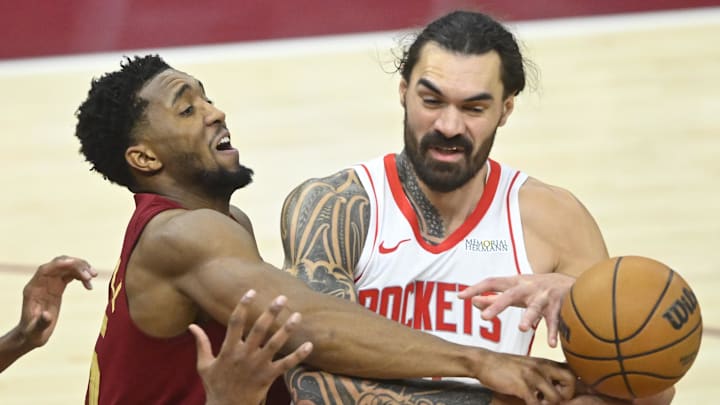 Jan 25, 2025; Cleveland, Ohio, USA; Cleveland Cavaliers guard Donovan Mitchell (45) defends Houston Rockets center Steven Adams (12) in the fourth quarter at Rocket Mortgage FieldHouse. Mandatory Credit: David Richard-Imagn Images