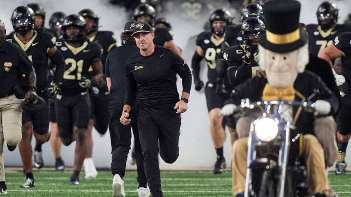 Sep 18, 2026; Winston-Salem, North Carolina, USA; Wake Forest Demon Deacons head coach Jake Dickert leads his team onto the field against the Miami (FL) Hurricanes during the first half at Allegacy Federal Credit Union Stadium. Mandatory Credit: Jim Dedmon-Imagn Images Sep 18, 2026; Winston-Salem, North Carolina, USA; Wake Forest Demon Deacons head coach Jake Dickert leads his team onto the field against the Miami (FL) Hurricanes during the first half at Allegacy Federal Credit Union Stadium. Mandatory Credit: Jim Dedmon-Imagn Images