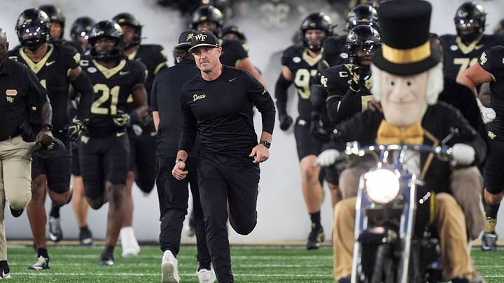 Sep 18, 2026; Winston-Salem, North Carolina, USA; Wake Forest Demon Deacons head coach Jake Dickert leads his team onto the field against the Miami (FL) Hurricanes during the first half at Allegacy Federal Credit Union Stadium. Mandatory Credit: Jim Dedmon-Imagn Images Sep 18, 2026; Winston-Salem, North Carolina, USA; Wake Forest Demon Deacons head coach Jake Dickert leads his team onto the field against the Miami (FL) Hurricanes during the first half at Allegacy Federal Credit Union Stadium. Mandatory Credit: Jim Dedmon-Imagn Images