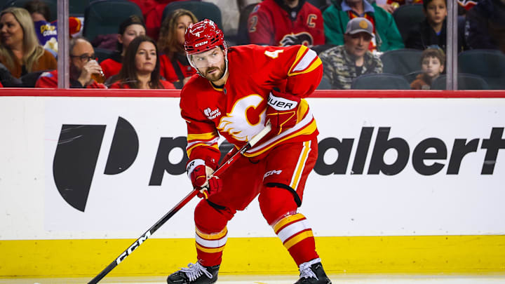 Jan 3, 2026; Calgary, Alberta, CAN; Calgary Flames defenseman Rasmus Andersson (4) controls the puck against the Nashville Predators during the second period at Scotiabank Saddledome. Mandatory Credit: Sergei Belski-Imagn Images