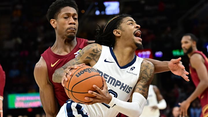 Feb 23, 2025; Cleveland, Ohio, USA; Memphis Grizzlies guard Ja Morant (12) drives to the basket against Cleveland Cavaliers forward De'Andre Hunter (12) during the second half at Rocket Arena. Mandatory Credit: Ken Blaze-Imagn Images