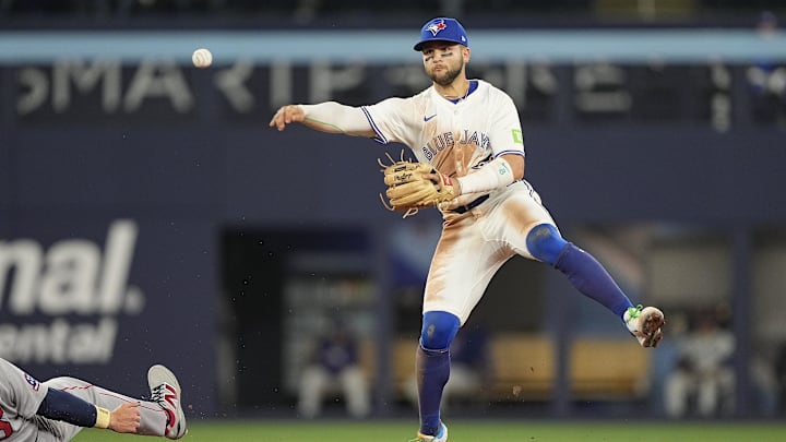 Apr 29, 2025; Toronto, Ontario, CAN; Toronto Blue Jays shortstop Bo Bichette (11) throws to first after getting Boston Red Sox first baseman Triston Casas (36) out at second during the eighth inning at Rogers Centre. Mandatory Credit: John E. Sokolowski-Imagn Images