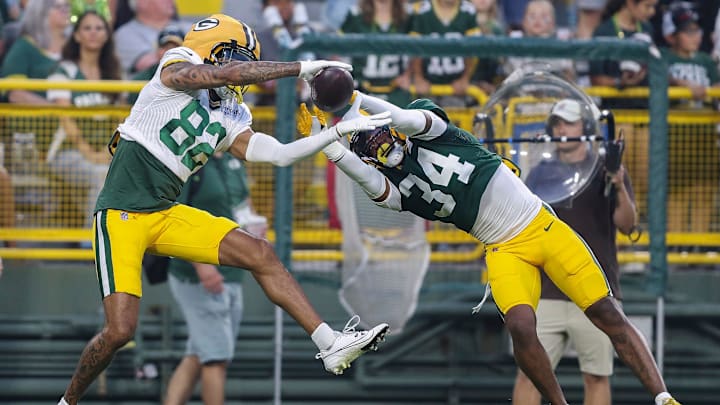 Green Bay Packers wide receiver Will Sheppard (82) and cornerback Kalen King (34) fight for a pass during Family Night.