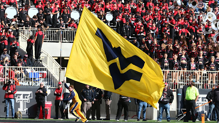Nov 30, 2024; Lubbock, Texas, USA; A West Virginia Mountaineers cheerleader celebrates after a touchdown against the Texas Tech Red Raiders in the second half at Jones AT&T Stadium and Cody Campbell Field. Mandatory Credit: Michael C. Johnson-Imagn Images