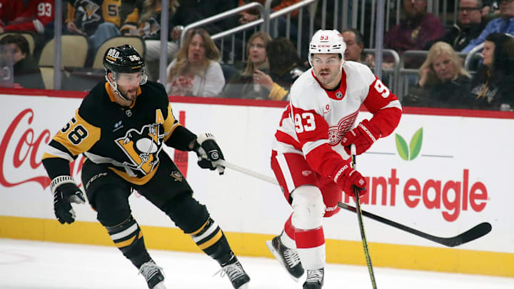 Nov 13, 2024; Pittsburgh, Pennsylvania, USA; Detroit Red Wings right wing Alex DeBrincat (93) skates with the puck against Pittsburgh Penguins defenseman Kris Letang (58) during the first period at PPG Paints Arena. Mandatory Credit: Charles LeClaire-Imagn Images Nov 13, 2024; Pittsburgh, Pennsylvania, USA; Detroit Red Wings right wing Alex DeBrincat (93) skates with the puck against Pittsburgh Penguins defenseman Kris Letang (58) during the first period at PPG Paints Arena. Mandatory Credit: Charles LeClaire-Imagn Images
