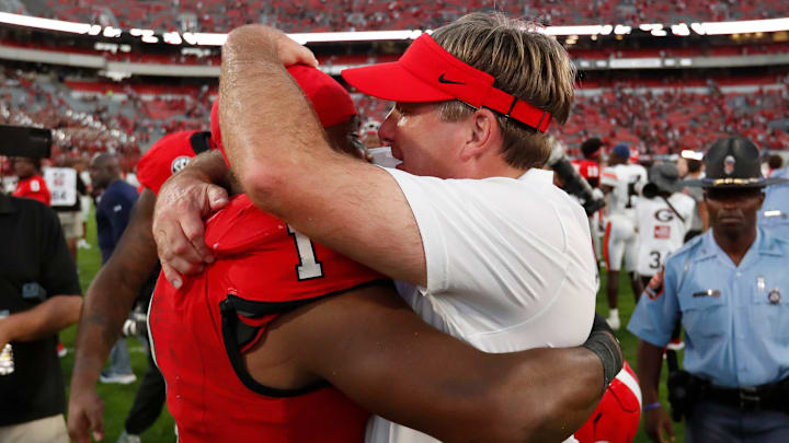 Georgia head coach Kirby Smart celebrates with Georgia running back Trevor Etienne (1) after winning a NCAA college football game against Auburn in Athens, Ga., on Saturday, Oct. 5, 2024. Georgia won 31-13.
