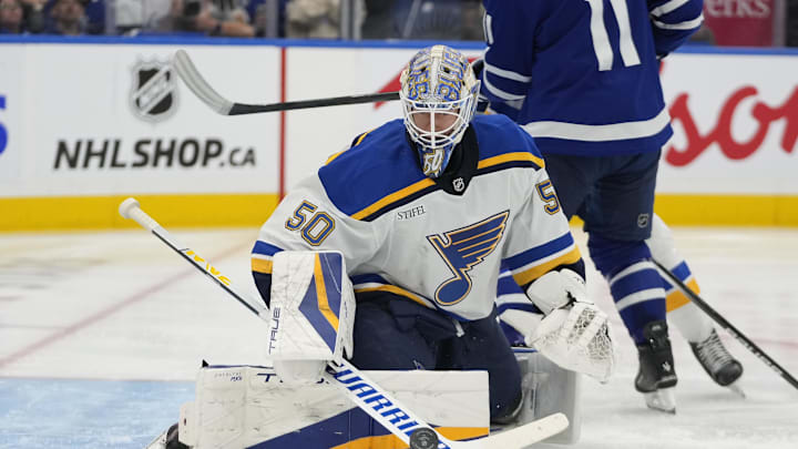 Oct 24, 2024; Toronto, Ontario, CAN; St. Louis Blues goaltender Jordan Binnington (50) makes a save against the Toronto Maple Leafs during the third period at Scotiabank Arena. Mandatory Credit: John E. Sokolowski-Imagn Images