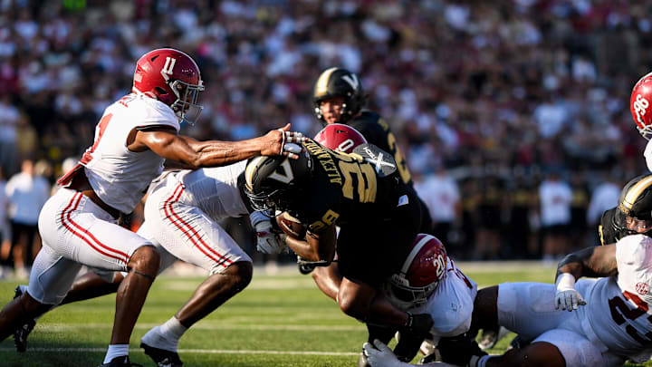 Oct 5, 2024; Nashville, Tennessee, USA;  Vanderbilt Commodores running back Sedrick Alexander (28) dives for the goal line as he drags Alabama Crimson Tide defensive lineman Jah-Marien Latham (20) during the first half at FirstBank Stadium. Mandatory Credit: Steve Roberts-Imagn Images