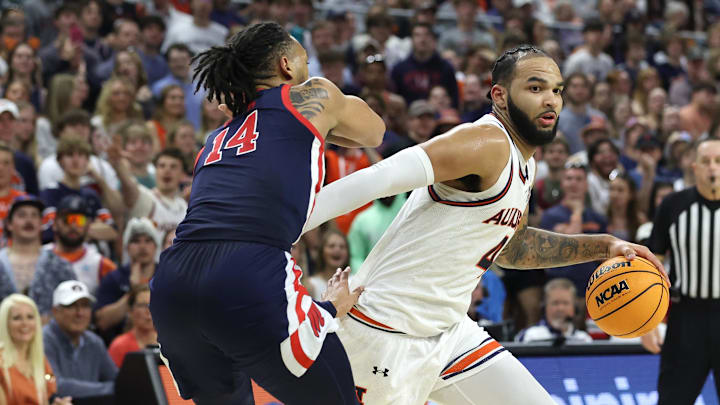 Feb 26, 2025; Auburn, Alabama, USA;  Auburn Tigers center Johni Broome (4) goes for a shot as Mississippi Rebels guard Dre Davis (14) defends during the second half at Neville Arena. Mandatory Credit: John Reed-Imagn Images