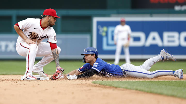 Sep 26, 2024; Washington, District of Columbia, USA; Kansas City Royals second baseman Adam Frazier (26) steals second base ahead of a tag by Washington Nationals second baseman Luis García Jr. (2) during the ninth inning at Nationals Park. Mandatory Credit: Geoff Burke-Imagn Images