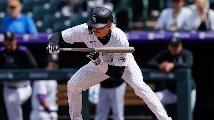 Apr 20, 2025; Denver, Colorado, USA; Colorado Rockies right fielder Zac Veen (13) is hit in the foot by a pitch in the fifth inning against the Washington Nationals at Coors Field. Mandatory Credit: Isaiah J. Downing-Imagn Images