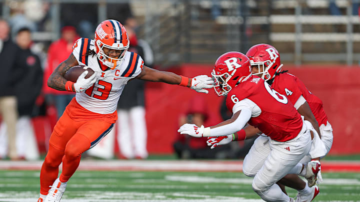 Nov 23, 2024; Piscataway, New Jersey, USA; Illinois Fighting Illini wide receiver Pat Bryant (13) gains yards after catch as Rutgers Scarlet Knights defensive back Shaquan Loyal (6) and defensive back Desmond Igbinosun (4) pursue during the second half at SHI Stadium. Mandatory Credit: Vincent Carchietta-Imagn Images