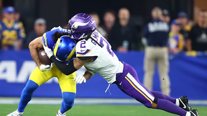 Jan 13, 2025; Glendale, AZ, USA; Los Angeles Rams wide receiver Puka Nacua (17) makes a catch against Minnesota Vikings cornerback Stephon Gilmore (2) during the second half in an NFC wild card game at State Farm Stadium. Mandatory Credit: Mark J. Rebilas-Imagn Images