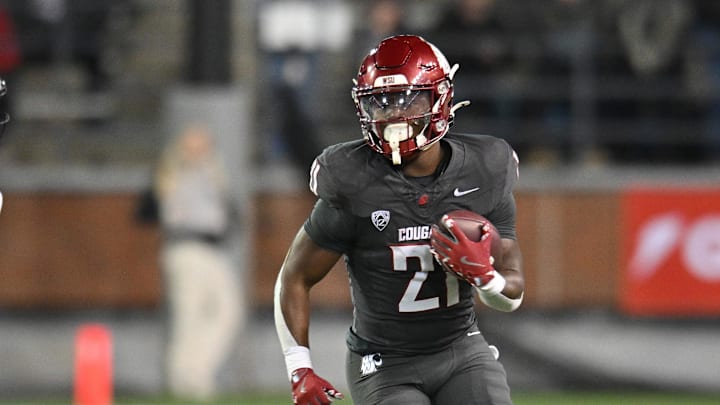 Nov 9, 2024; Pullman, Washington, USA; Washington State Cougars running back Wayshawn Parker (21) runs the ball against the Utah State Aggies in the second half at Gesa Field at Martin Stadium. Mandatory Credit: James Snook-Imagn Images