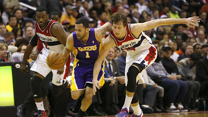 Nov 26, 2013; Washington, DC, USA; Los Angeles Lakers point guard Jordan Farmar (1) battles for the ball with Washington Wizards point guard John Wall (2) and Wizards power forward Jan Vesely (24) in the fourth quarter at Verizon Center. The Wizards won 116-111. Mandatory Credit: Geoff Burke-Imagn Images