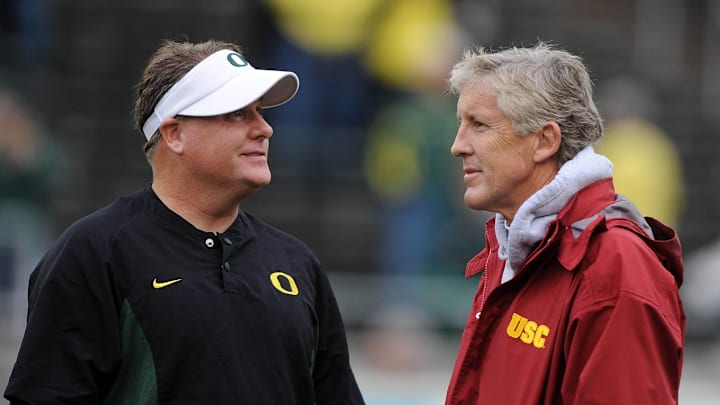 Oct 31, 2009; Eugene, OR, USA; Oregon Ducks coach Chip Kelly (left) and Southern California Trojans coach Pete Carroll (right) before the game at Autzen Stadium. Mandatory Credit: Kirby Lee/Image of Sport-Imagn Images