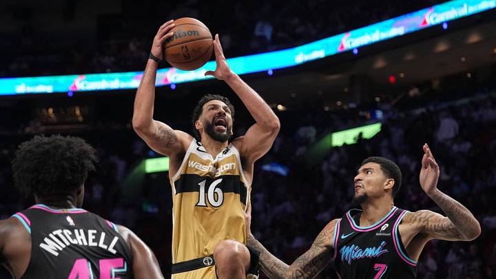 Apr 4, 2026; Miami, Florida, USA;  Washington Wizards forward Anthony Gill (16) drives to the basket as Miami Heat center Kel'el Ware (7) defends during the second half at Kaseya Center. Mandatory Credit: Jim Rassol-Imagn Images