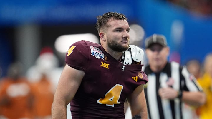 Jan 1, 2025; Atlanta, GA, USA; Arizona State Sun Devils running back Cam Skattebo (4) reacts after losing his helmet while being tackled by Texas Longhorns defensive back Michael Taaffe (16) during the second half of the Peach Bowl at Mercedes-Benz Stadium. Mandatory Credit: Dale Zanine-Imagn Images