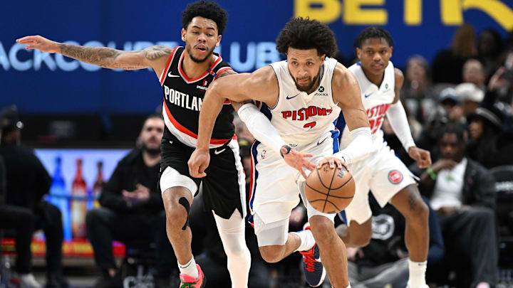 Jan 6, 2025; Detroit, Michigan, USA; Detroit Pistons guard Cade Cunningham (2) drives the ball up the court against Portland Trail Blazers guard Anfernee Simons (1) in the fourth quarter at Little Caesars Arena. Mandatory Credit: Lon Horwedel-Imagn Images