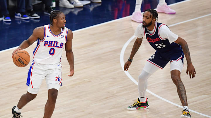 Nov 6, 2024; Inglewood, California, USA; Philadelphia 76ers guard Tyrese Maxey (0) moves the ball against Los Angeles Clippers forward Derrick Jones Jr. (55) during the first half at Intuit Dome. Mandatory Credit: Gary A. Vasquez-Imagn Images