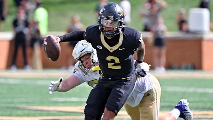 Sep 27, 2025; Winston-Salem, North Carolina, USA; Georgia Tech Yellow Jackets defensive lineman Jordan van den Berg (99) attempts to tackle Wake Forest Demon Deacons quarterback Robby Ashford (2) during the fourth quarter at Allegacy Federal Credit Union Stadium. Mandatory Credit: Zachary Taft-Imagn Images Sep 27, 2025; Winston-Salem, North Carolina, USA; Georgia Tech Yellow Jackets defensive lineman Jordan van den Berg (99) attempts to tackle Wake Forest Demon Deacons quarterback Robby Ashford (2) during the fourth quarter at Allegacy Federal Credit Union Stadium. Mandatory Credit: Zachary Taft-Imagn Images