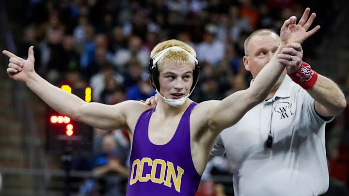 Oconomowoc High School's Kellen Wolbert holds up three fingers after winning his third state title in the Division 1 144-pound championship match during the WIAA state individual wrestling tournament on Saturday, March 1, 2025, at the Kohl Center in Madison, Wis. Tork Mason/USA TODAY NETWORK-Wisconsin'
