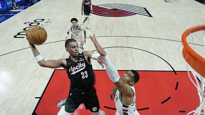 Jan 28, 2025; Portland, Oregon, USA; Portland Trail Blazers forward Toumani Camara (33) looks to pass the ball against Milwaukee Bucks power forward Giannis Antetokounmpo (34, right) during the second half at Moda Center. Mandatory Credit: Soobum Im-Imagn Images