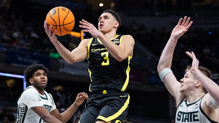 Mar 14, 2025; Indianapolis, IN, USA; Oregon Ducks guard Jackson Shelstad (3)  shoots the ball while Michigan State Spartans guard Jase Richardson (11) defends in the second half  at Gainbridge Fieldhouse. Mandatory Credit: Trevor Ruszkowski-Imagn Images