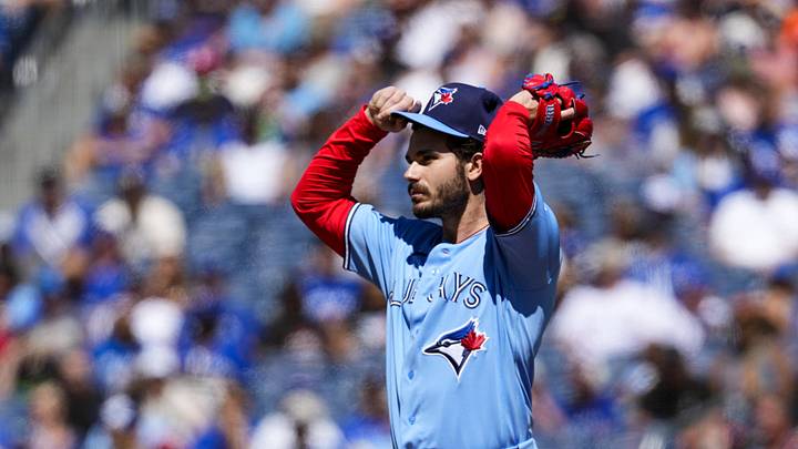 Toronto Blue Jays pitcher Dylan Cease adjusts his hat.