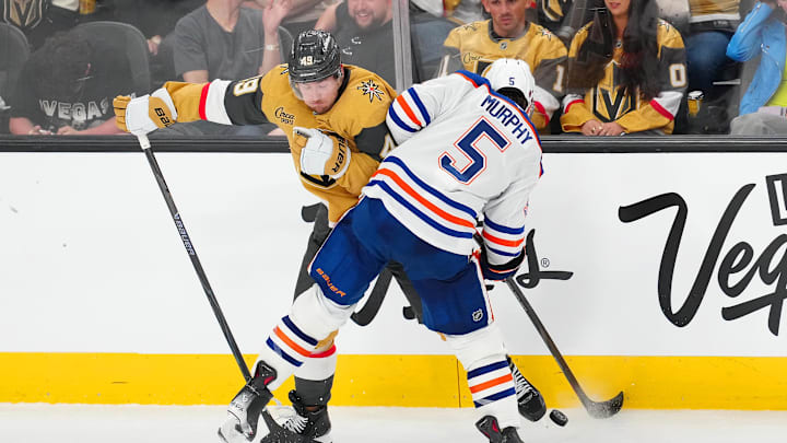 Mar 26, 2026; Las Vegas, Nevada, USA; Edmonton Oilers defenseman Connor Murphy (5) checks Vegas Golden Knights left wing Ivan Barbashev (49) during the third period at T-Mobile Arena. Mandatory Credit: Stephen R. Sylvanie-Imagn Images