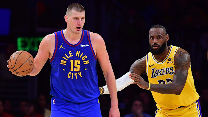 Apr 25, 2024; Los Angeles, California, USA; Denver Nuggets center Nikola Jokic (15) controls the ball against Los Angeles Lakers forward LeBron James (23)  during the second half in game three of the first round for the 2024 NBA playoffs at Crypto.com Arena.