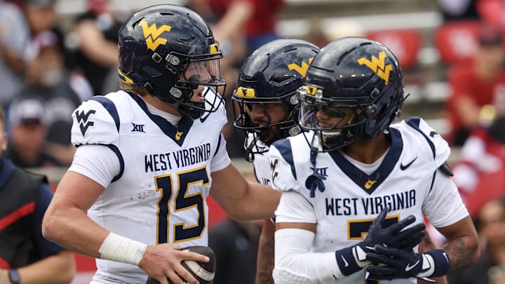 Nov 1, 2025; Houston, Texas, USA; West Virginia Mountaineers quarterback Scotty Fox Jr. (15) celebrates his touchdown with wide receiver Jarod Bowie (7) and teammates against the Houston Cougars in the first half at TDECU Stadium. Mandatory Credit: Thomas Shea-Imagn Images