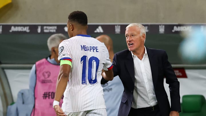 Kylian Mbappe of France (L) and Coach Didier Deschamps of...