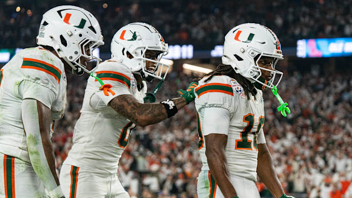 Miami Hurricanes wide receiver Keelan Marion (0) pats Malachi Toney (10) on the back after his touchdown during the CFP Fiesta Bowl at the State Farm Stadium, in Glendale, Ariz., on Thursday, Jan. 8, 2026.